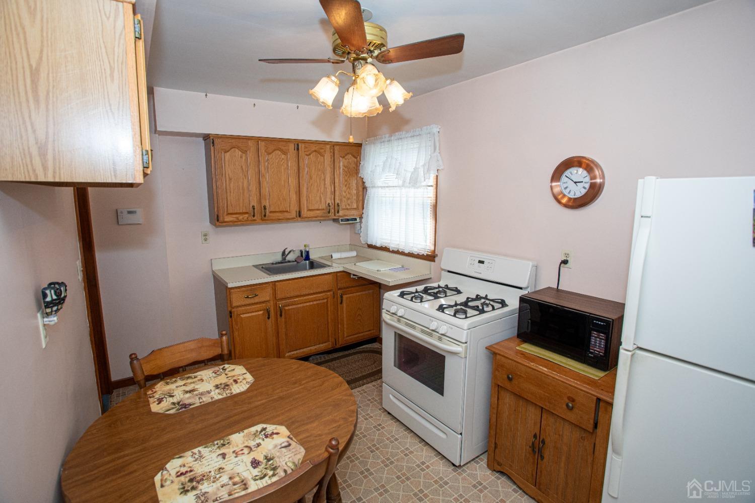 9 Becker Drive Sayreville, NJ 08859 - Photo 3 of 39 a kitchen with a stove a sink and a refrigerator