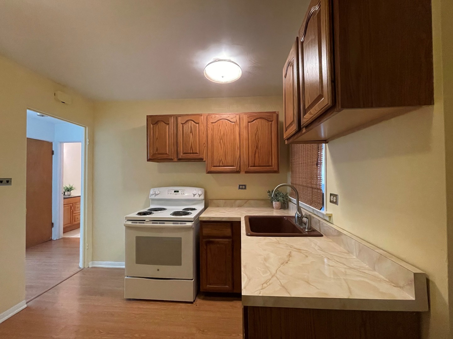 341 Custer Avenue, Unit 2 Evanston, IL 60202 - Photo 11 of 19 a kitchen with granite countertop a sink a stove and refrigerator