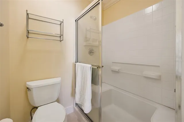 a bathroom with a toilet and a shower