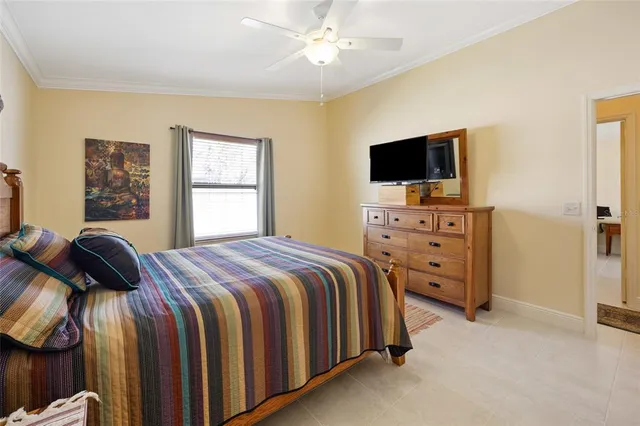 a bedroom with a bed and a television