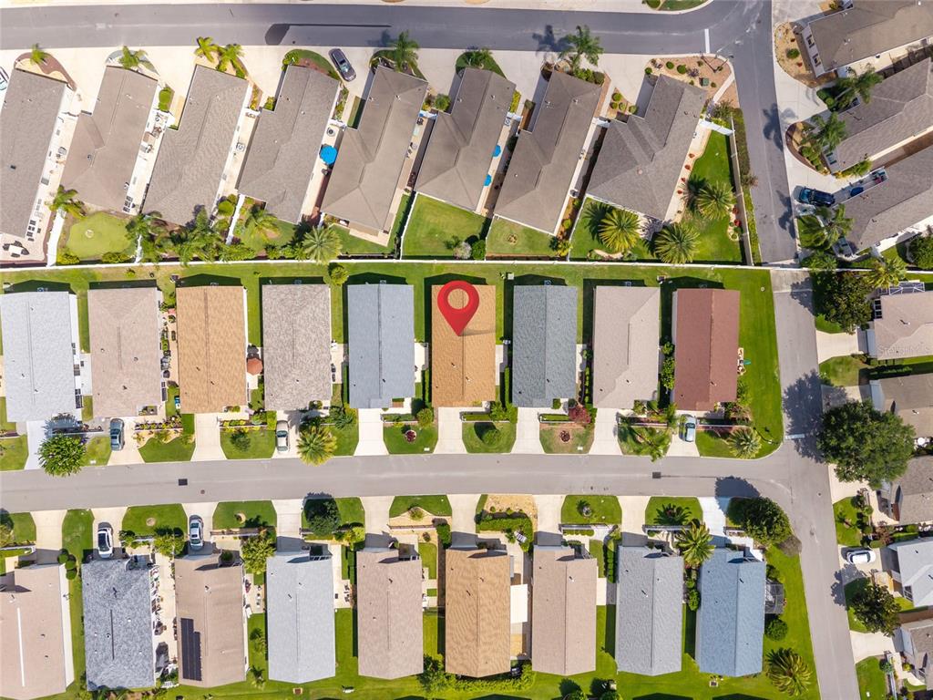 2372 Travis Place The Villages, FL 32162 - Photo 26 of 33 a bunch of flowers sitting in front of a building