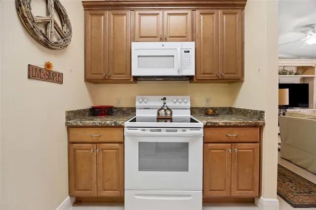 a kitchen with stainless steel appliances granite countertop a stove and a microwave