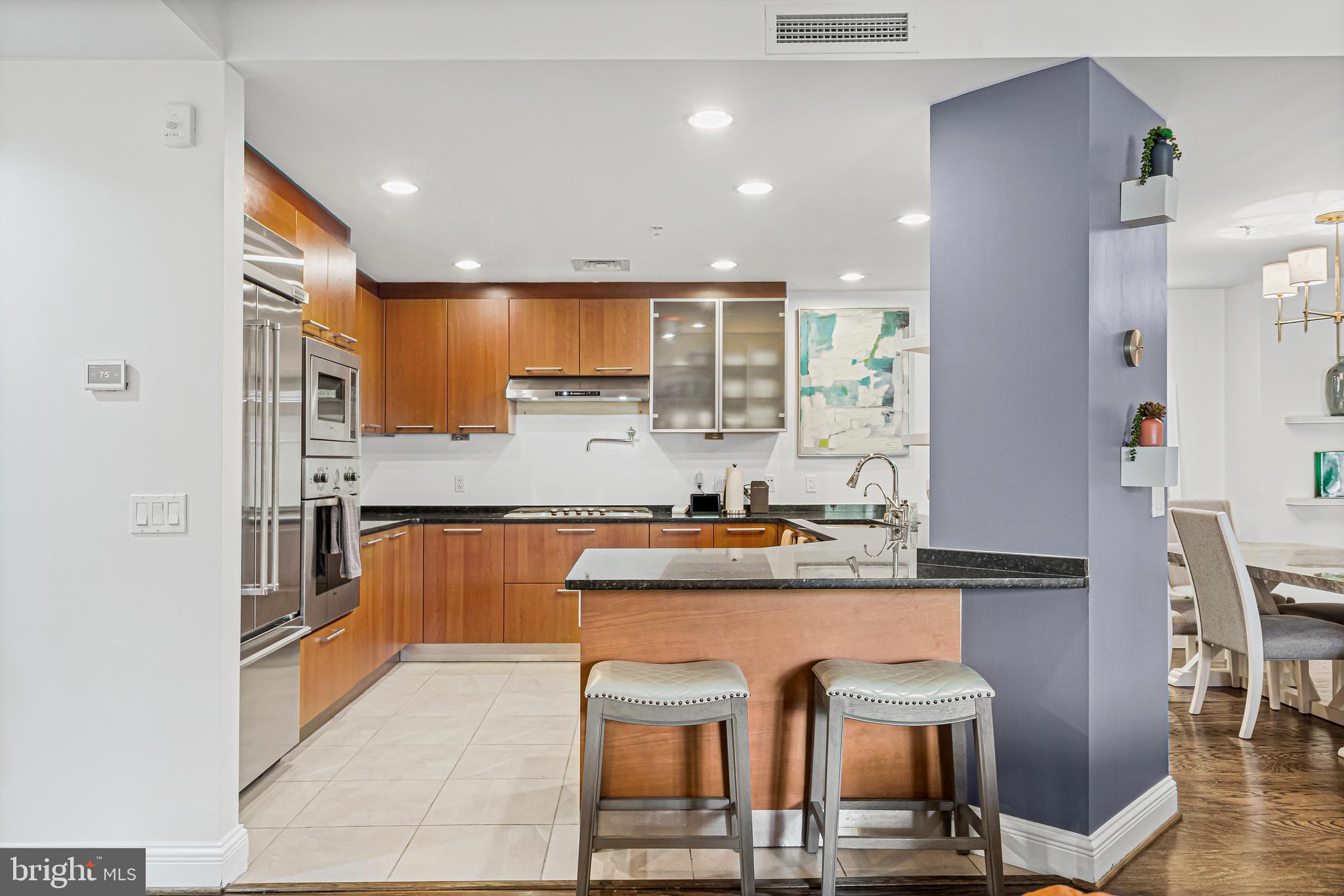 801 Key Highway, Unit 345 Baltimore, MD 21230 - Photo 13 of 57 a kitchen with stainless steel appliances granite countertop a stove a sink and a refrigerator