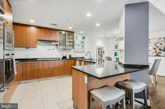 a kitchen with granite countertop a sink and cabinets