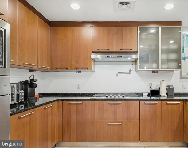 a kitchen with stainless steel appliances a refrigerator sink and microwave