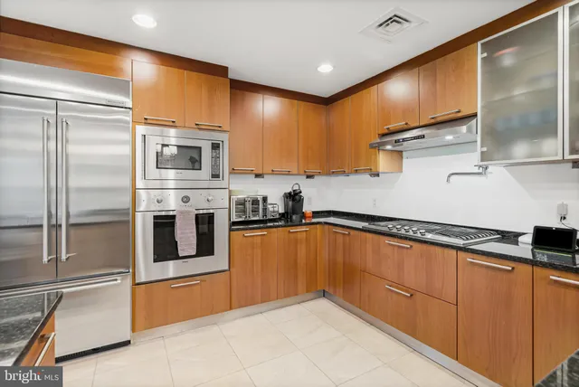 a kitchen with stainless steel appliances granite countertop a sink and cabinets