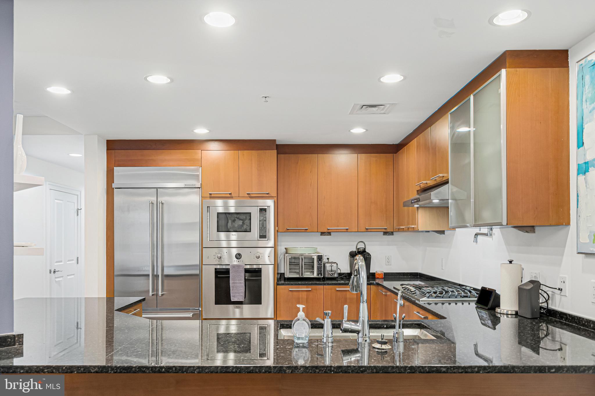 801 Key Highway, Unit 345 Baltimore, MD 21230 - Photo 17 of 57 a kitchen with stainless steel appliances granite countertop a sink and cabinets