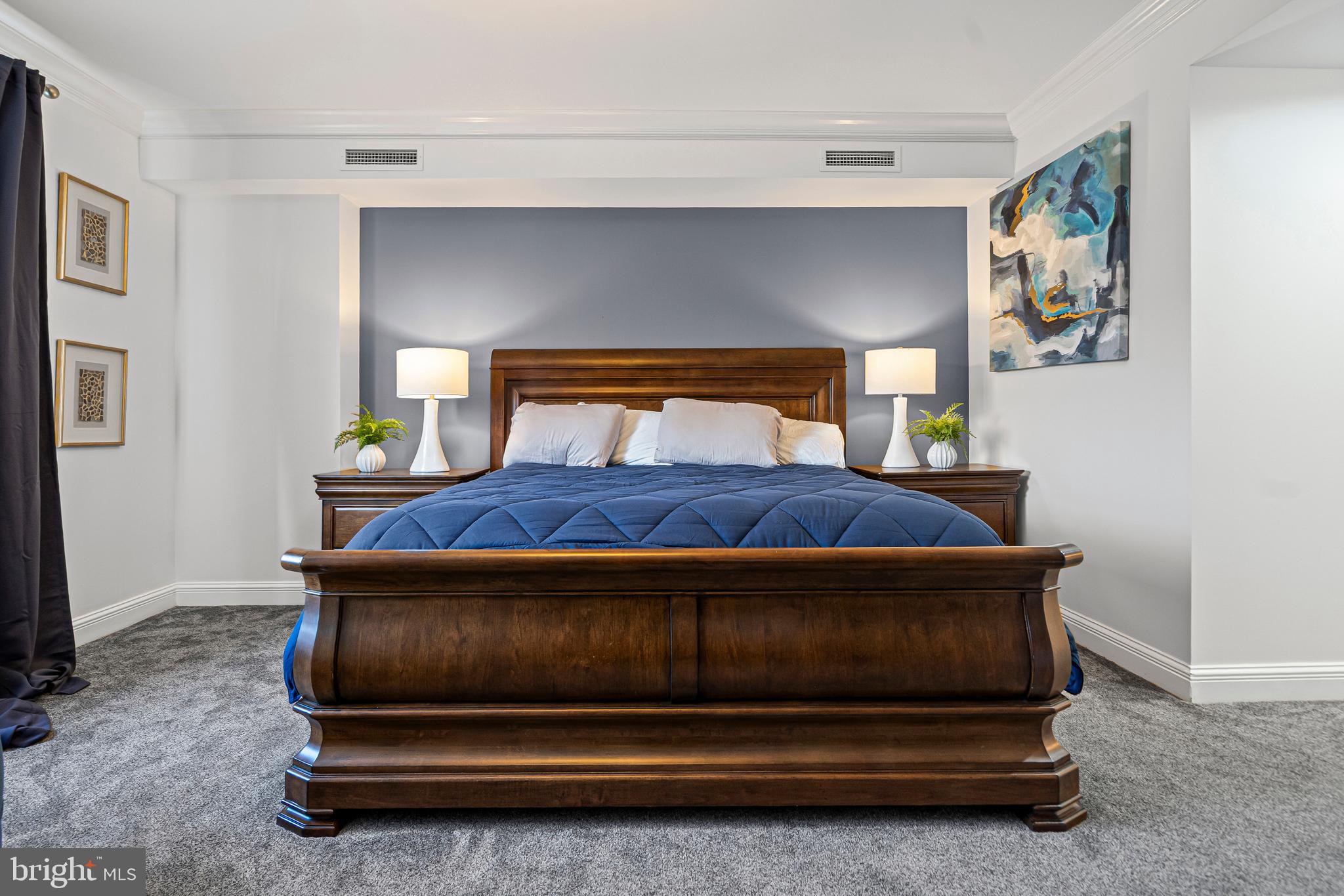 801 Key Highway, Unit 345 Baltimore, MD 21230 - Photo 20 of 57 a bedroom with a bed and painting on the wall