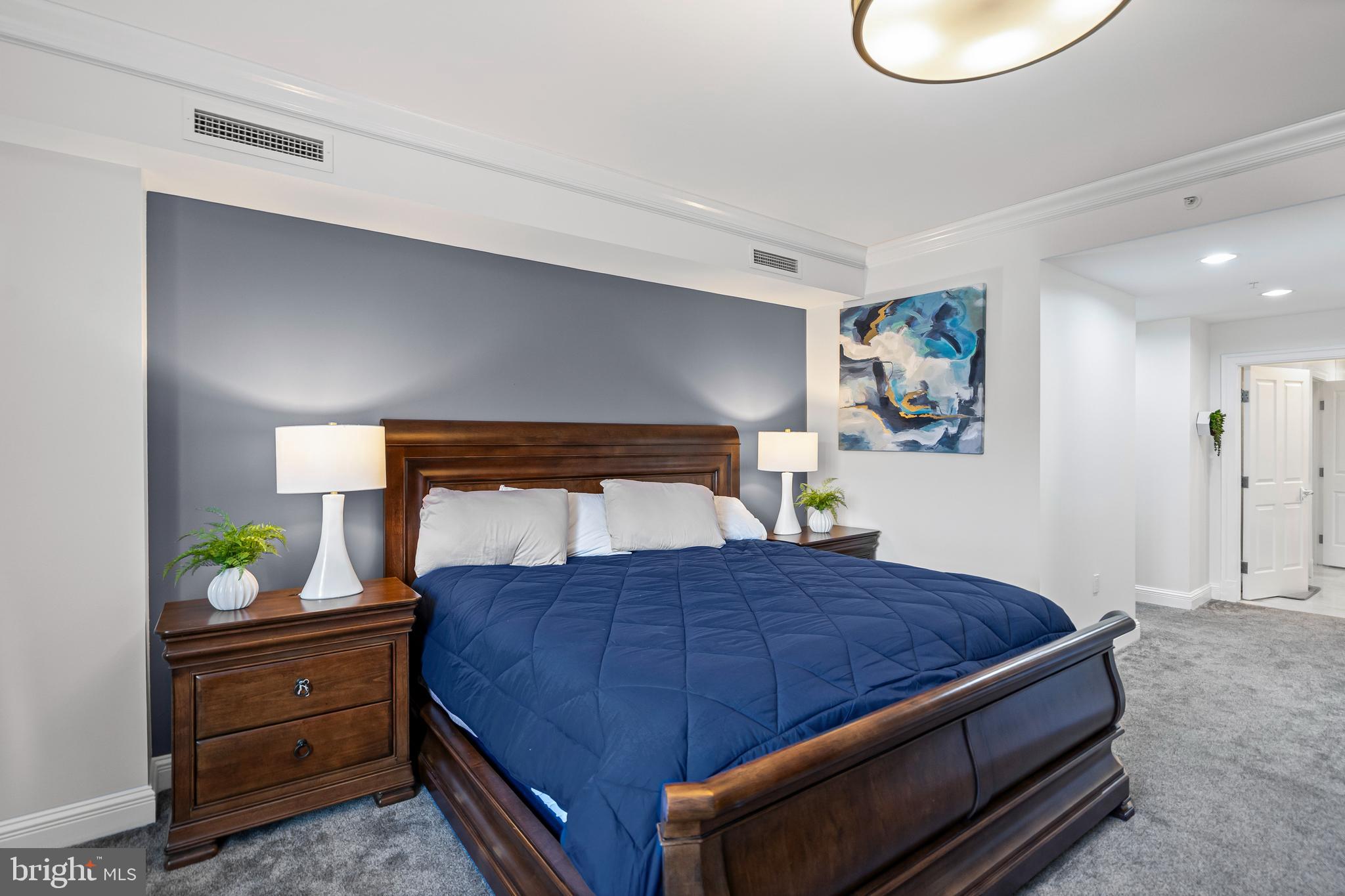 801 Key Highway, Unit 345 Baltimore, MD 21230 - Photo 21 of 57 a bedroom with a bed and painting on the wall