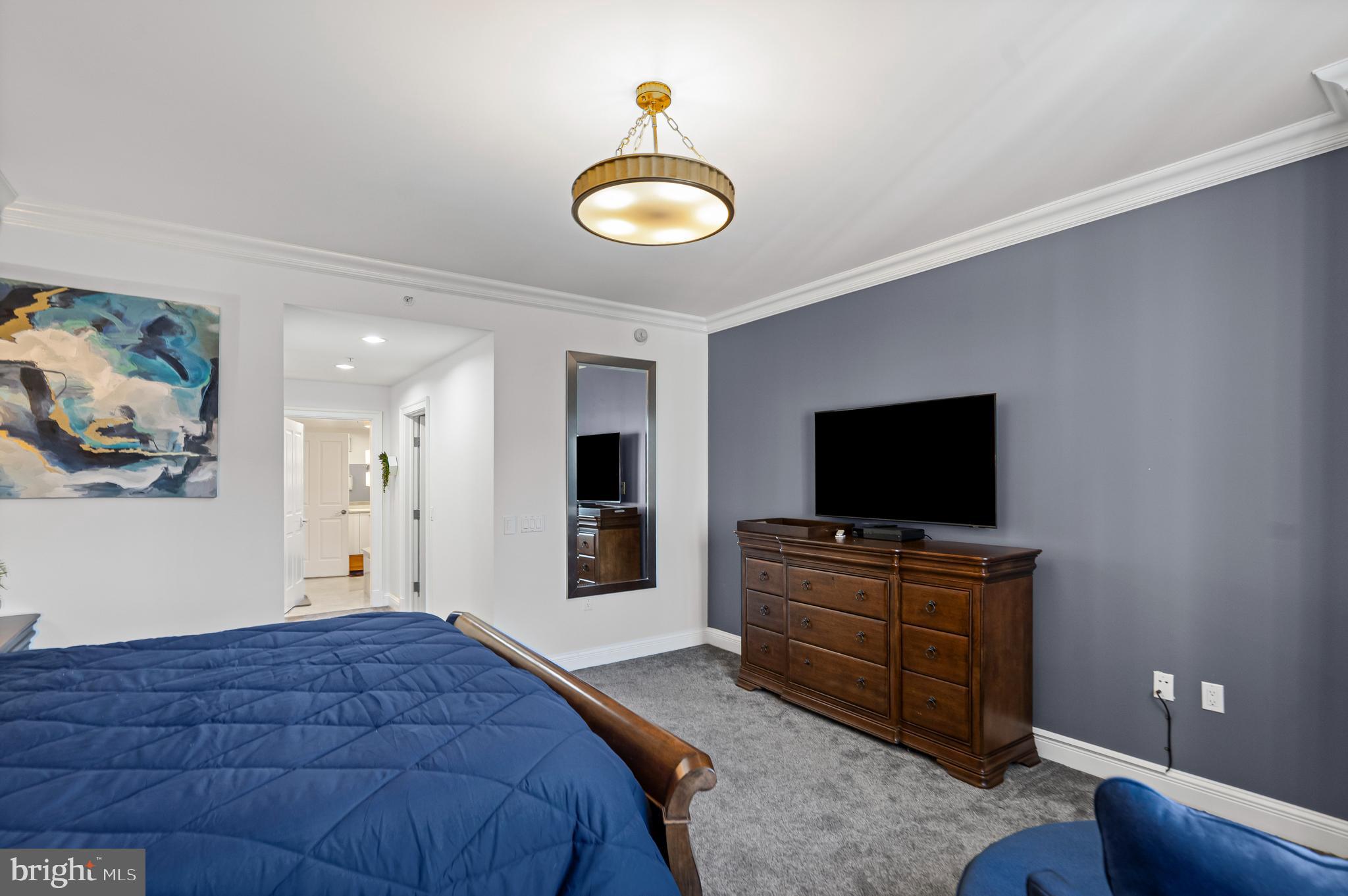 801 Key Highway, Unit 345 Baltimore, MD 21230 - Photo 22 of 57 a bedroom with a bed and a flat screen tv