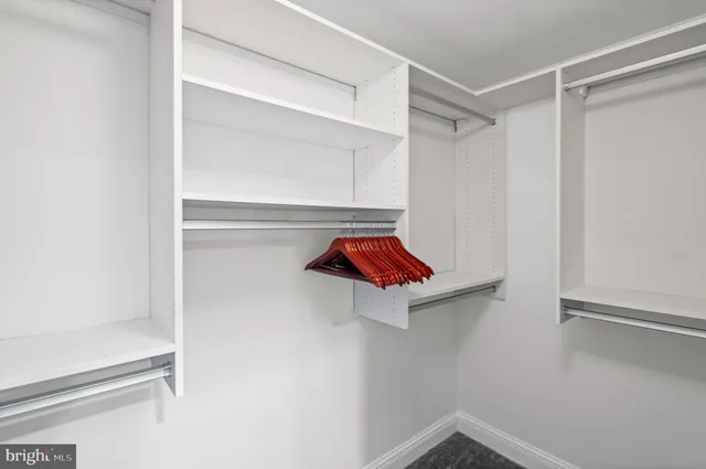 a bedroom with a bed and painting on the wall