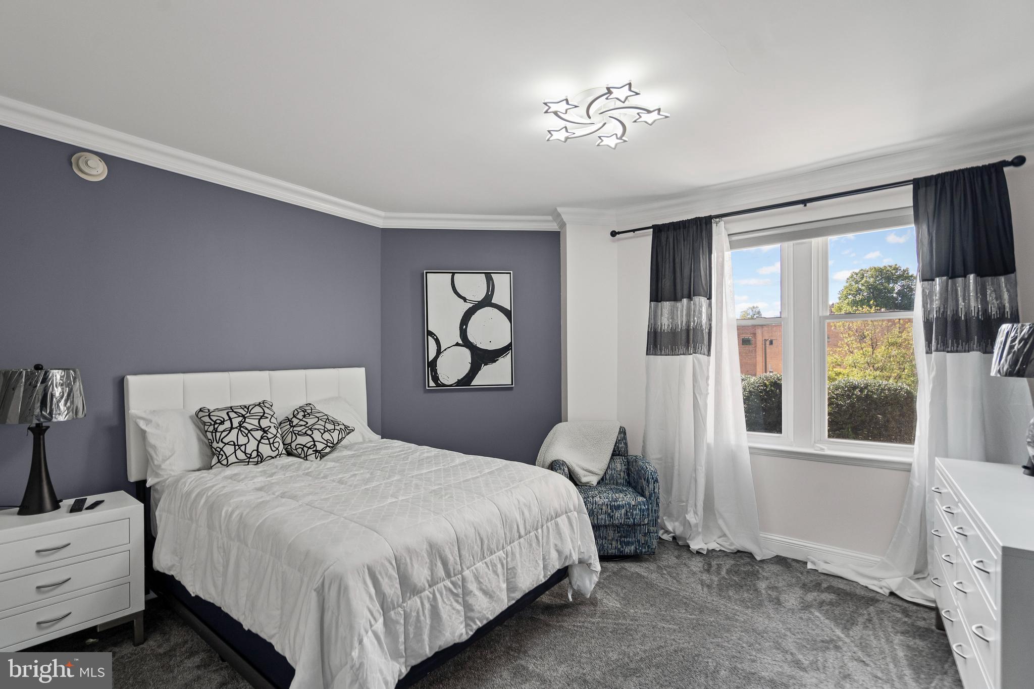 801 Key Highway, Unit 345 Baltimore, MD 21230 - Photo 29 of 57 a bedroom with a bed and a window