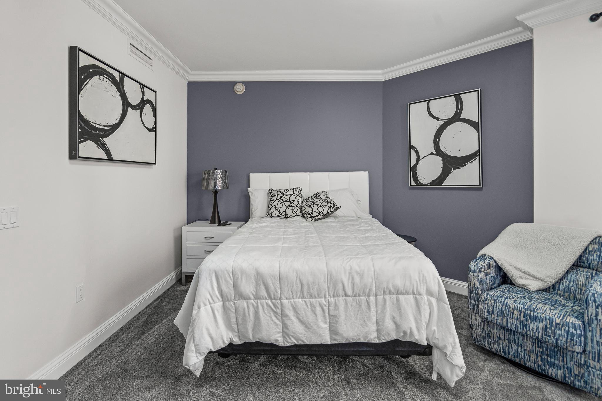 801 Key Highway, Unit 345 Baltimore, MD 21230 - Photo 30 of 57 a bedroom with a bed and painting on the wall