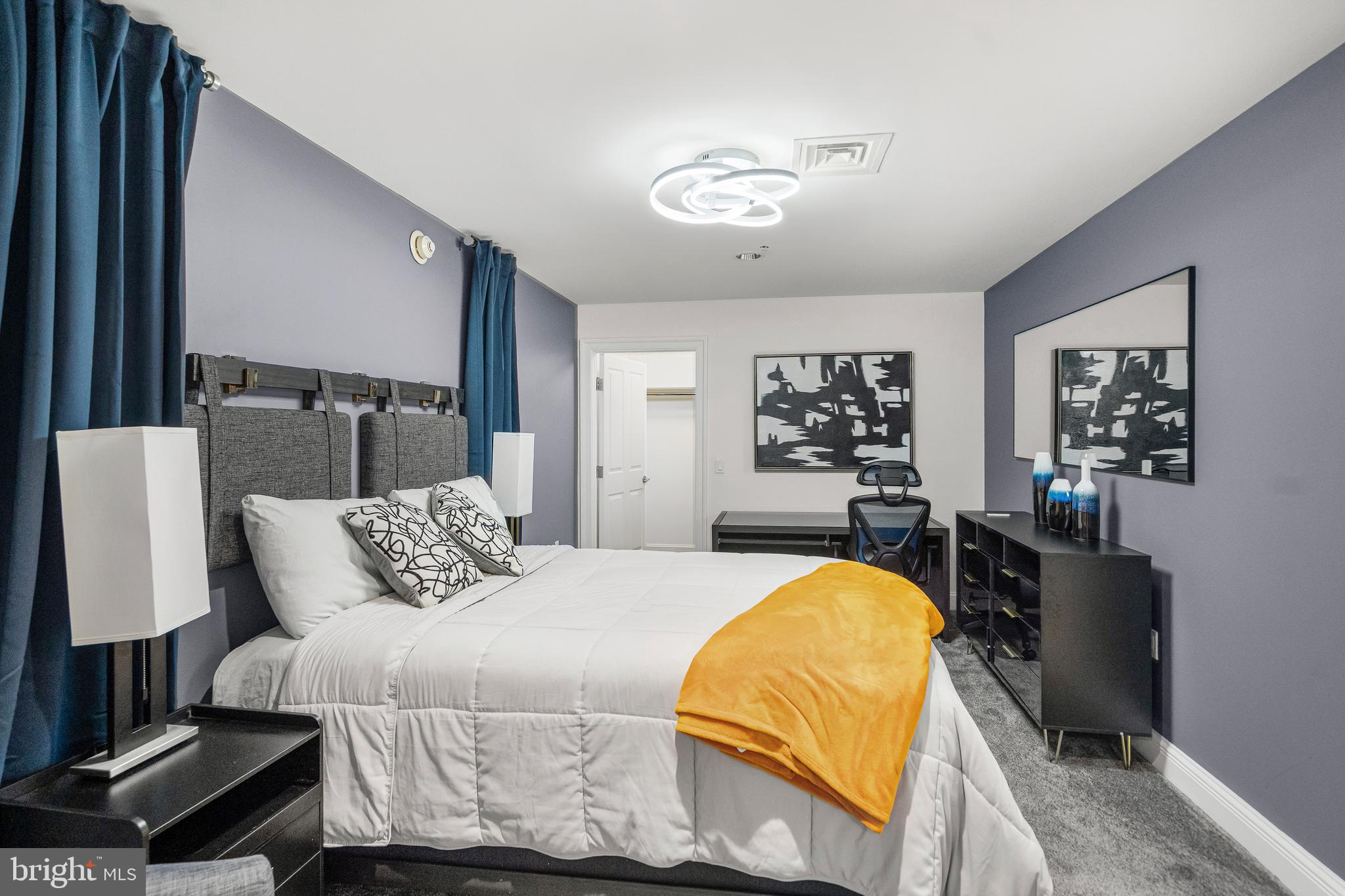 801 Key Highway, Unit 345 Baltimore, MD 21230 - Photo 33 of 57 a bedroom with a bed and wooden floor