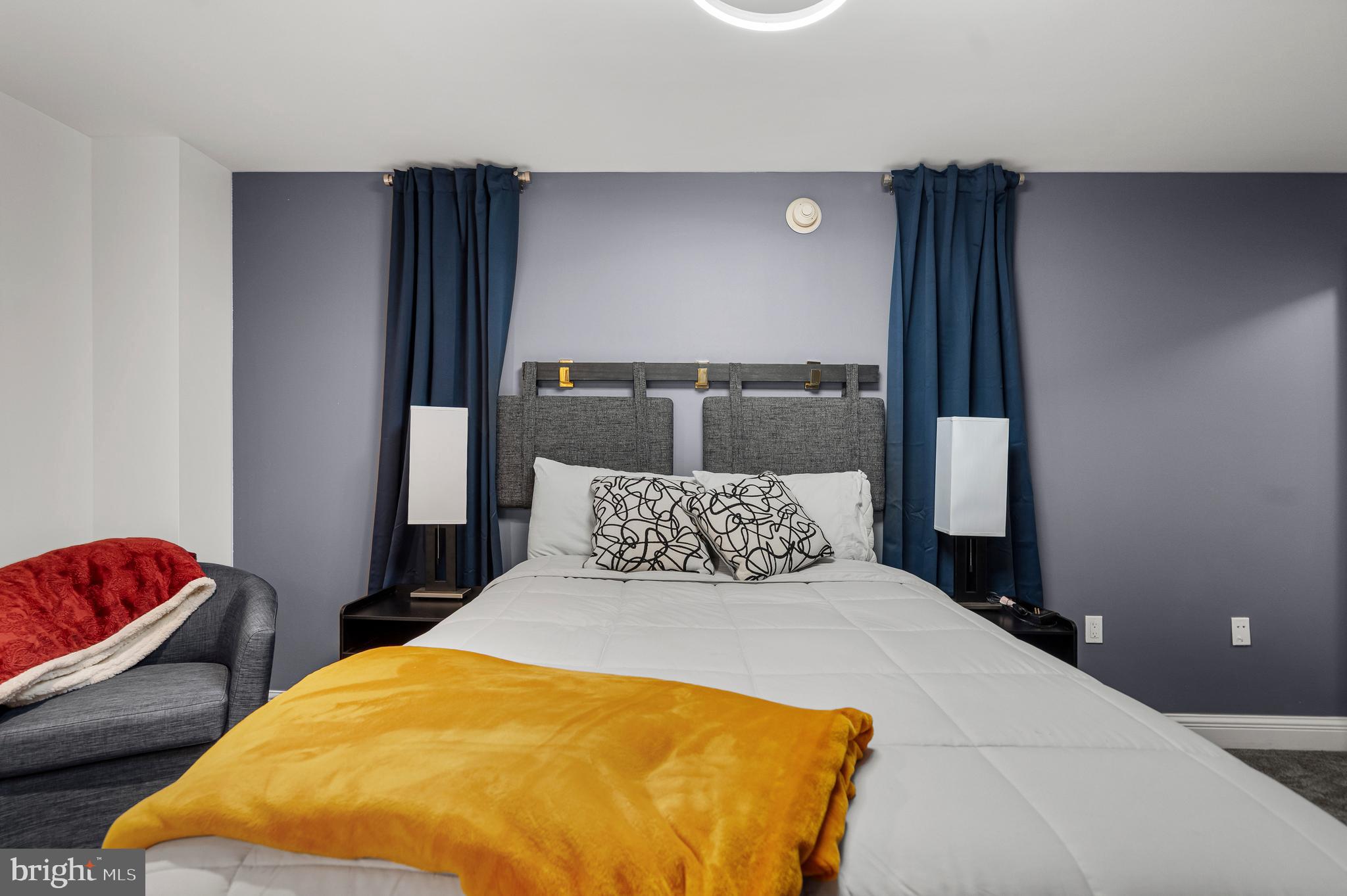 801 Key Highway, Unit 345 Baltimore, MD 21230 - Photo 34 of 57 a bedroom with a bed and wooden floor