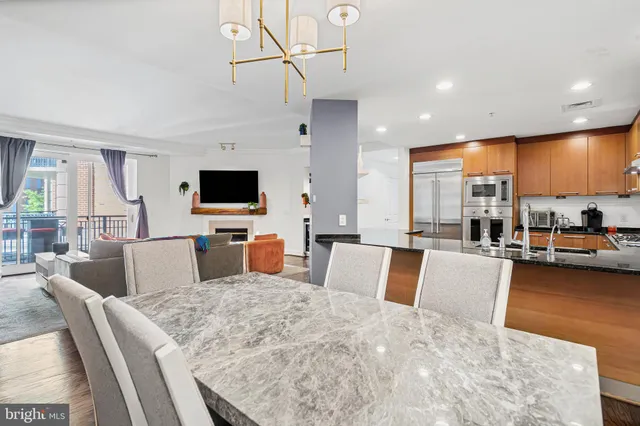 a view of a dining room with furniture wooden floor and a chandelier