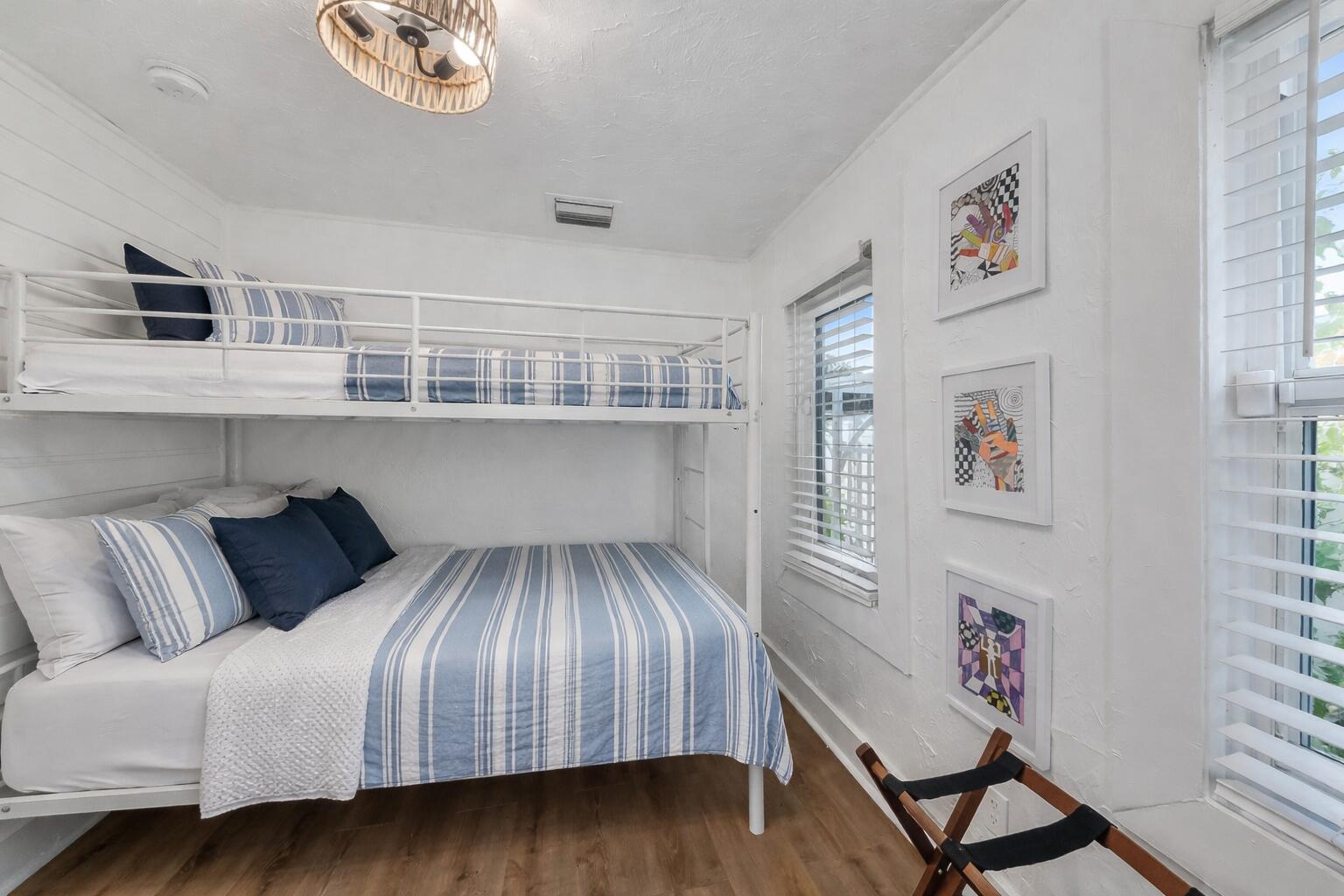 308 Southwest 1st Street Delray Beach, FL 33444 - Photo 14 of 26 a bedroom with a large bed and a chandelier