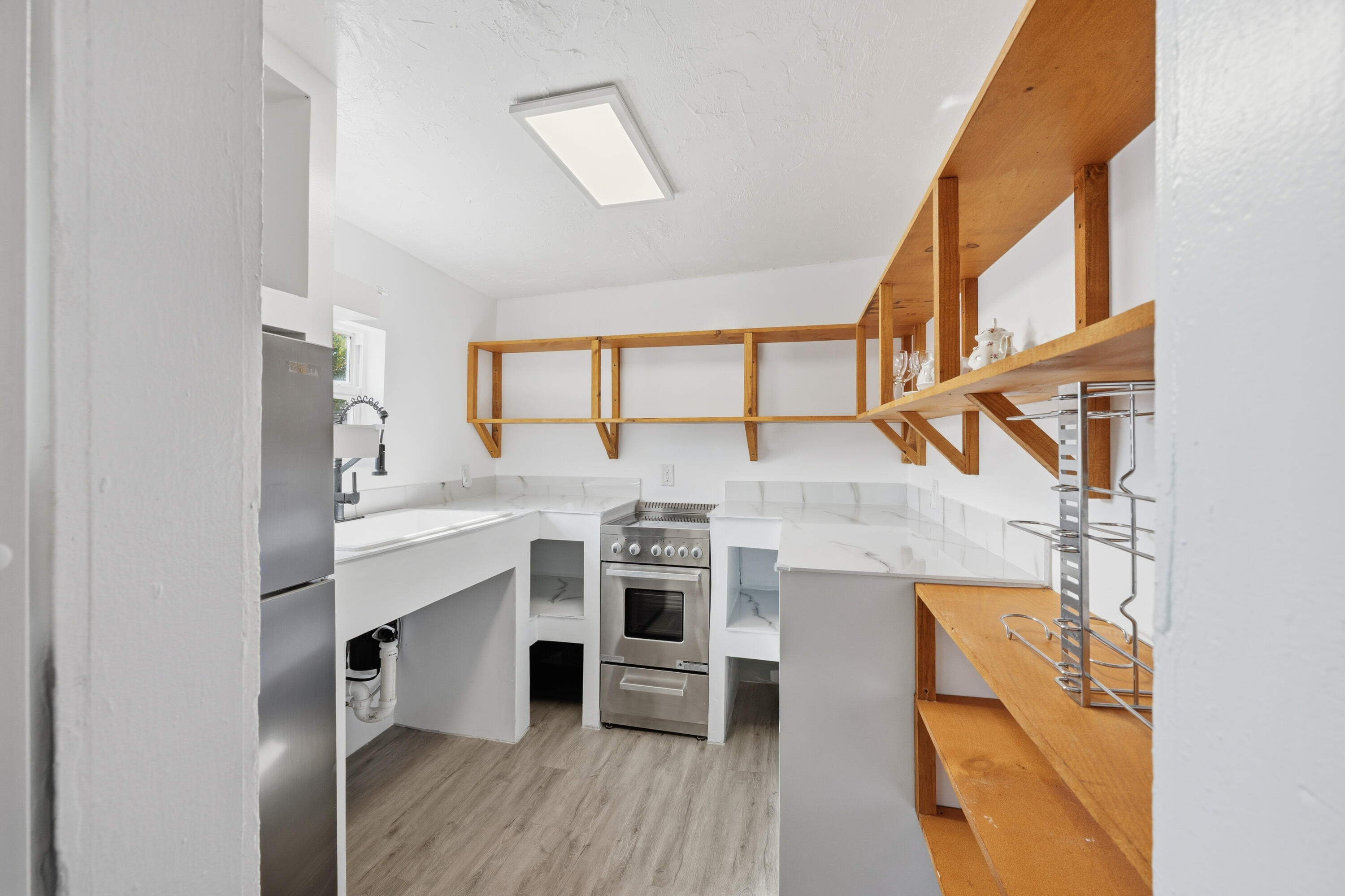 308 Southwest 1st Street Delray Beach, FL 33444 - Photo 8 of 26 a view of a kitchen with furniture and wooden floor
