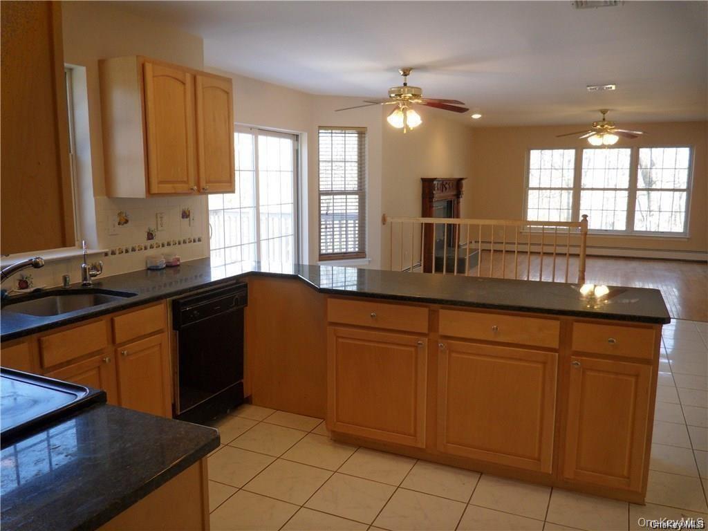 169 Cedar Cliff Road Monroe, NY 10950 - Photo 4 of 14 a kitchen with granite countertop sink cabinets and window