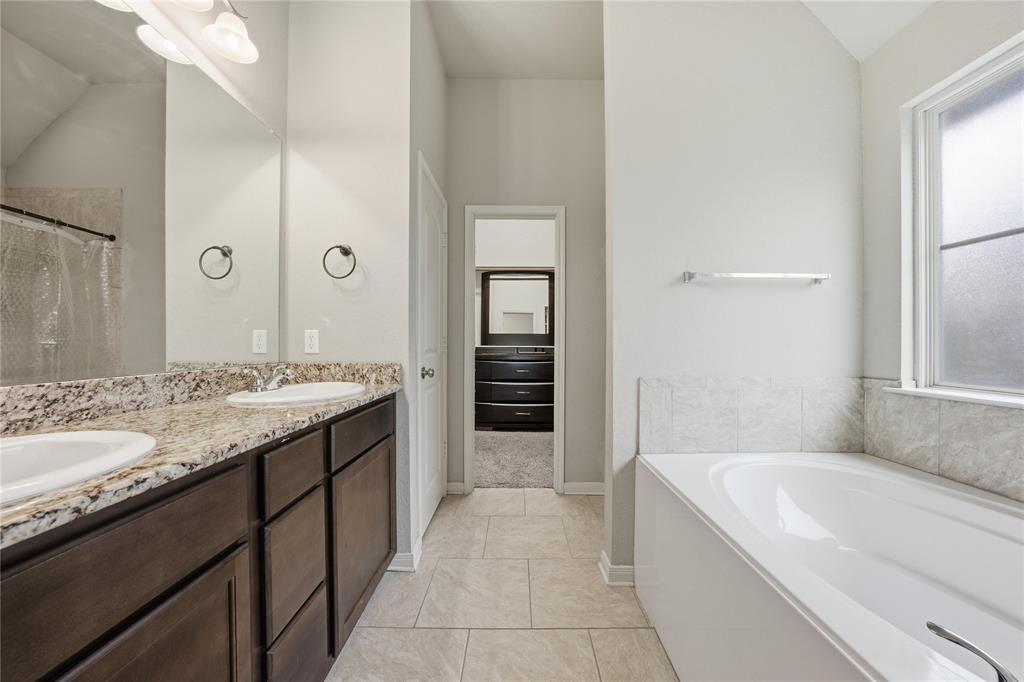 10808 Aurora Drive Waco, TX 76708 - Photo 16 of 23 a spacious bathroom with a granite countertop tub sink and mirror