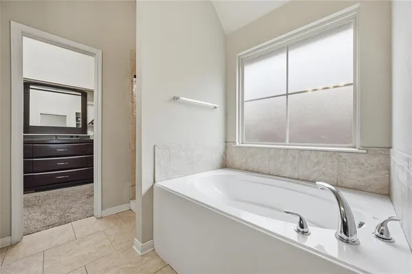 a bathroom with a tub and a sink