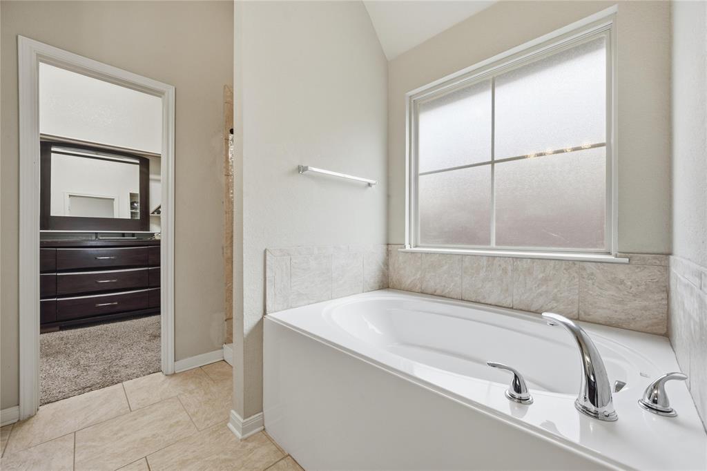 10808 Aurora Drive Waco, TX 76708 - Photo 17 of 23 a bathroom with a tub and a sink