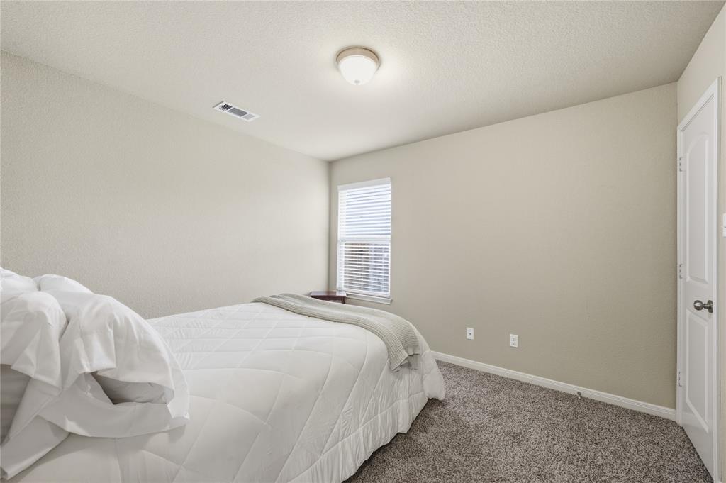 10808 Aurora Drive Waco, TX 76708 - Photo 18 of 23 a bedroom with a bed and a window