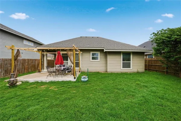 a view of a house with backyard porch and sitting area