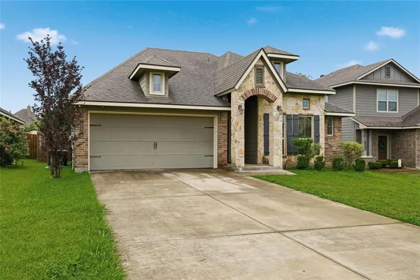 a front view of a house with garden