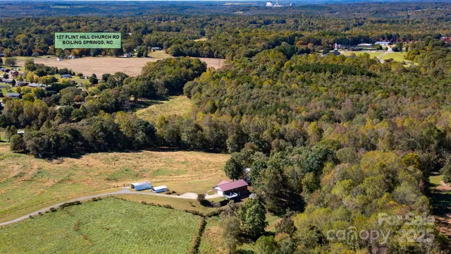 an aerial view of a houses with a yard