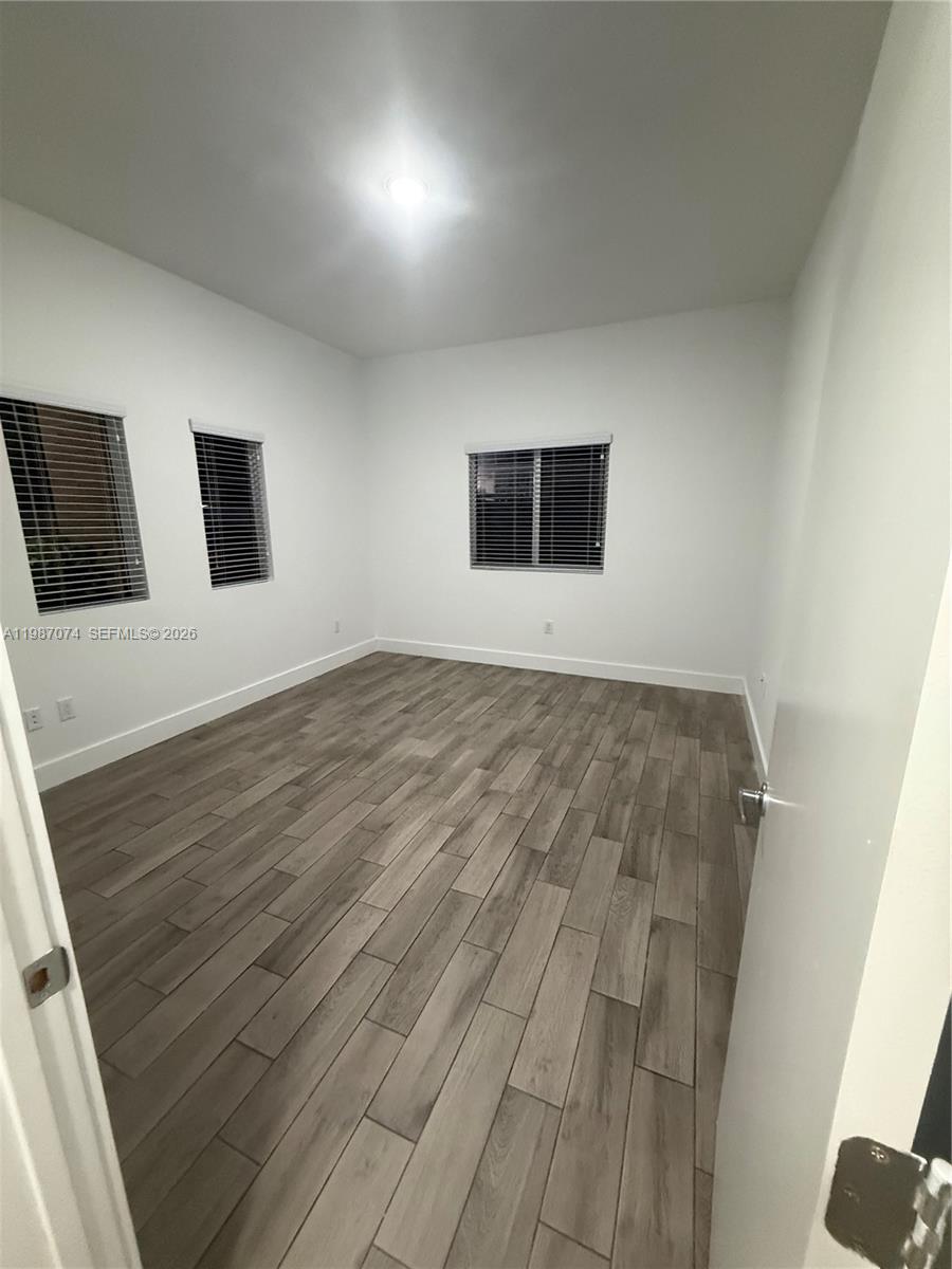 486 East 30th Street, Unit 202 Hialeah, FL 33013 - Photo 11 of 16 a view of a livingroom with wooden floor and windows