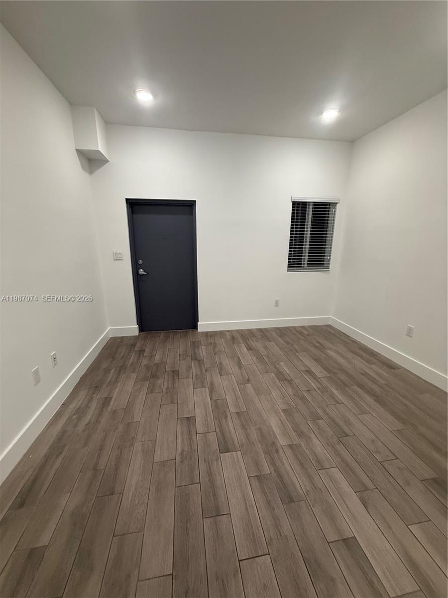 486 East 30th Street, Unit 202 Hialeah, FL 33013 - Photo 2 of 16 a view of an empty room with wooden floor