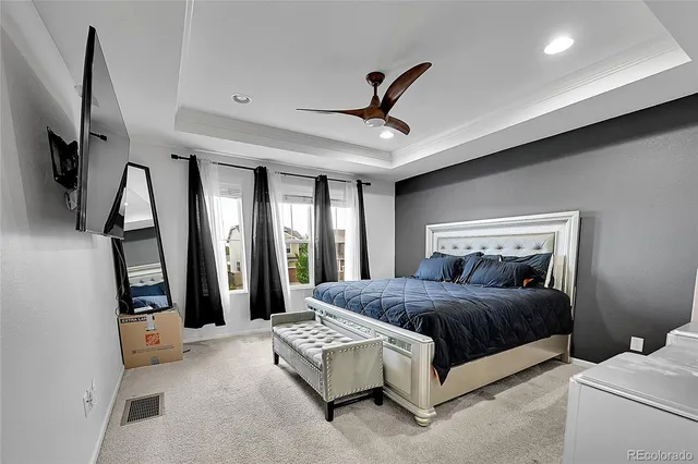 a bedroom with a bed couch and a window