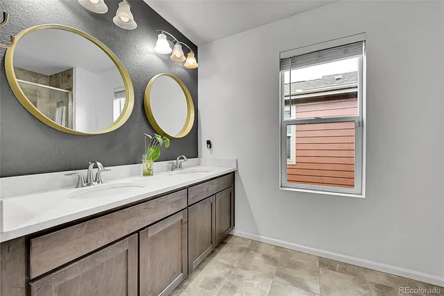 a bathroom with a double vanity sink and a mirror