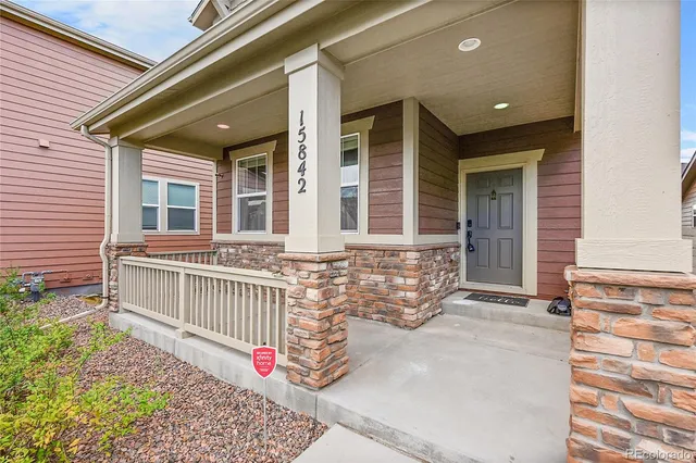 a front view of a house with wooden fence
