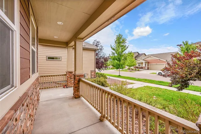 a view of an house with backyard and balcony