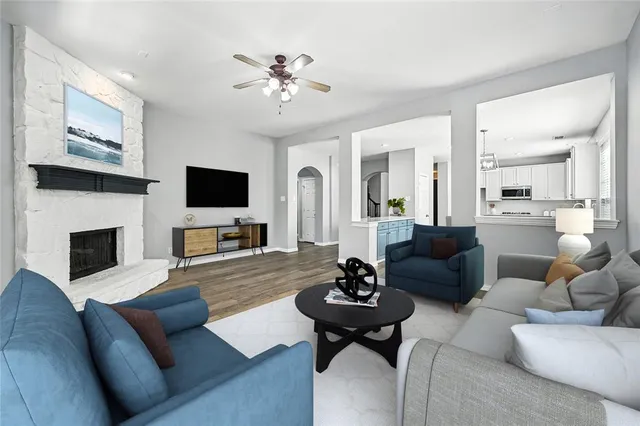 a living room with furniture a fireplace and a flat screen tv