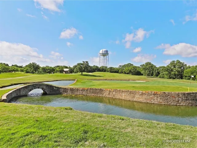 a view of a golf course with a lake view
