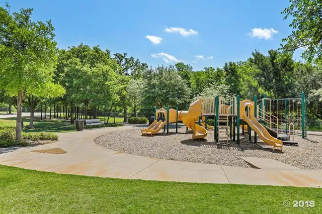 a view of a park with swings and slides