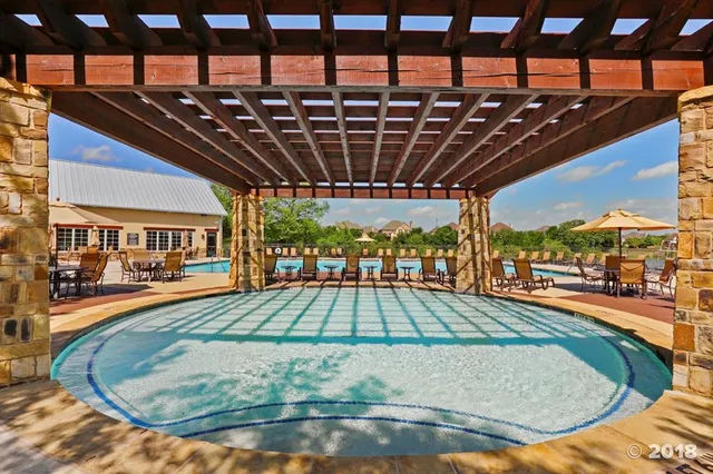 a view of a swimming pool with a patio