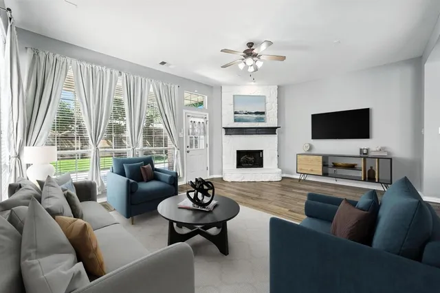 a living room with furniture a fireplace and a flat screen tv