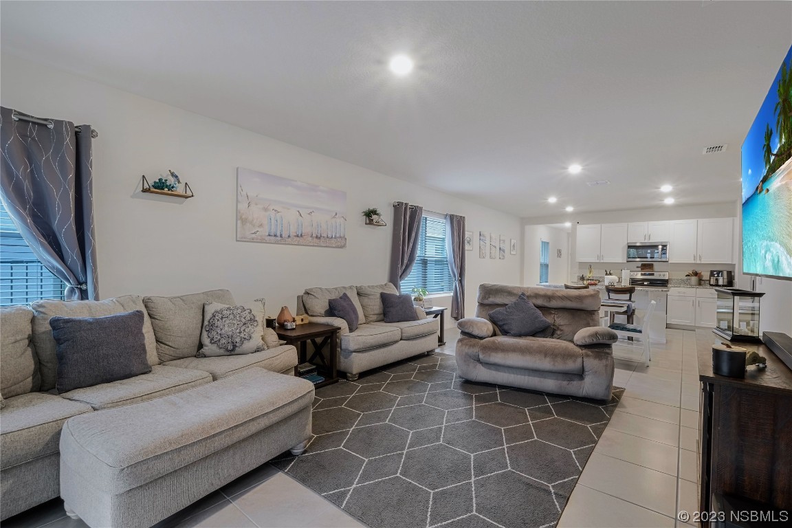 354 Camilla Road DeLand, FL 32724 - Photo 14 of 57 a living room with furniture and a flat screen tv