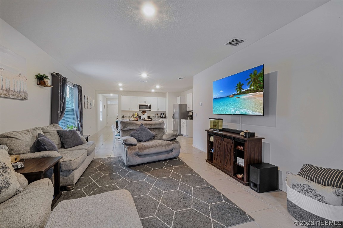354 Camilla Road DeLand, FL 32724 - Photo 16 of 57 a living room with furniture and a flat screen tv