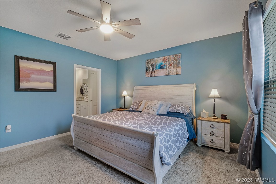 354 Camilla Road DeLand, FL 32724 - Photo 18 of 57 a bedroom with a bed and a chandelier