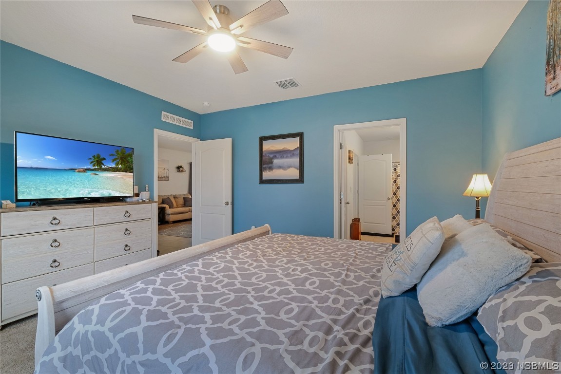 354 Camilla Road DeLand, FL 32724 - Photo 19 of 57 a bedroom with a bed and a flat screen tv in it