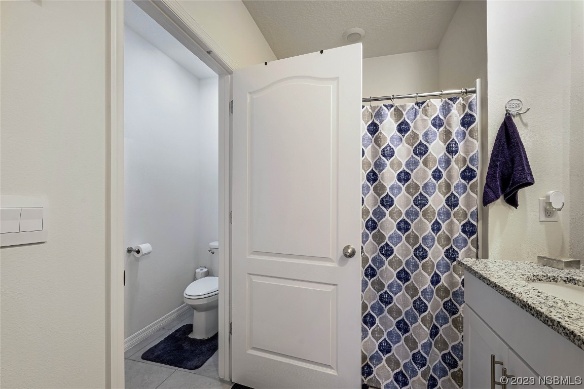 354 Camilla Road DeLand, FL 32724 - Photo 23 of 57 a bathroom with a granite countertop sink toilet and shower