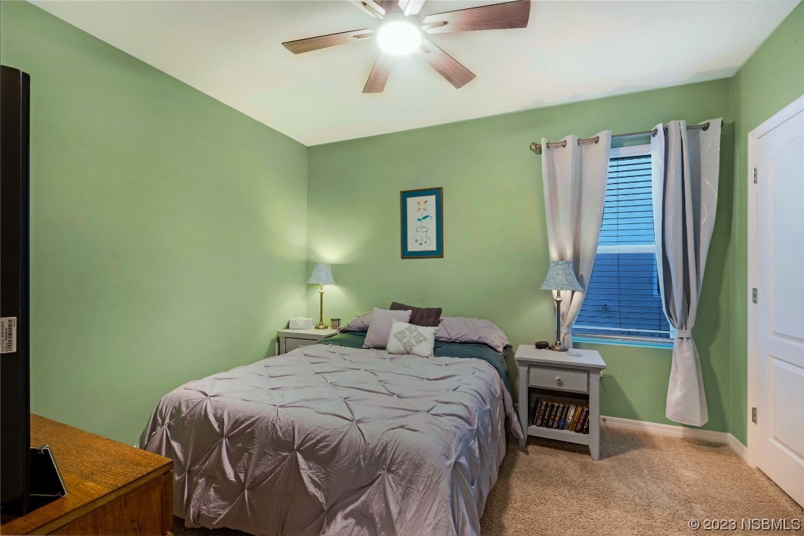 354 Camilla Road DeLand, FL 32724 - Photo 27 of 57 a bedroom with a bed and a chandelier