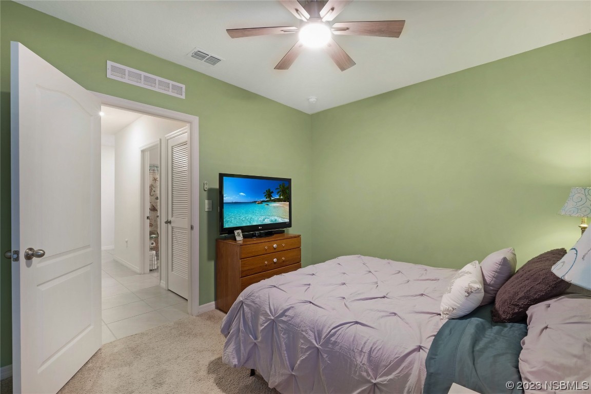 354 Camilla Road DeLand, FL 32724 - Photo 28 of 57 a bedroom with a bed and a chandelier