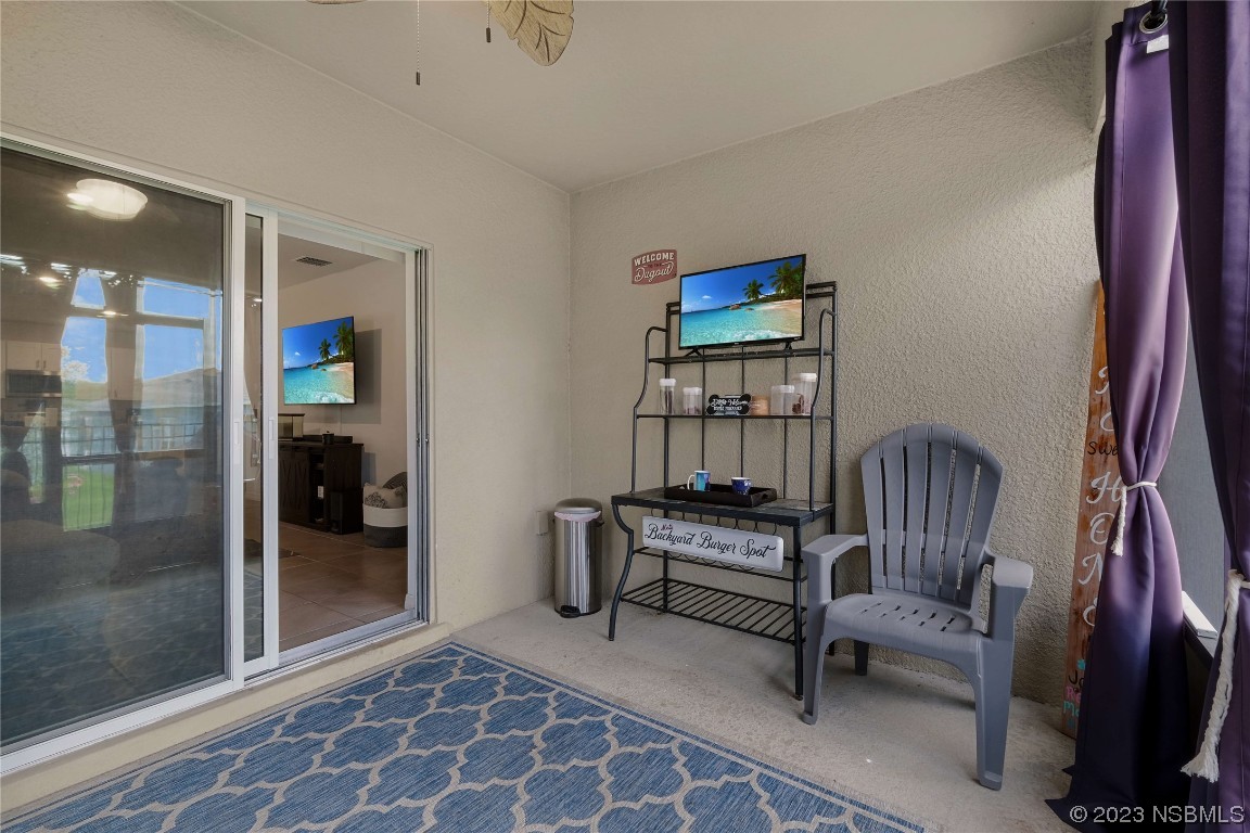 354 Camilla Road DeLand, FL 32724 - Photo 32 of 57 a living room with furniture a lamp and large window