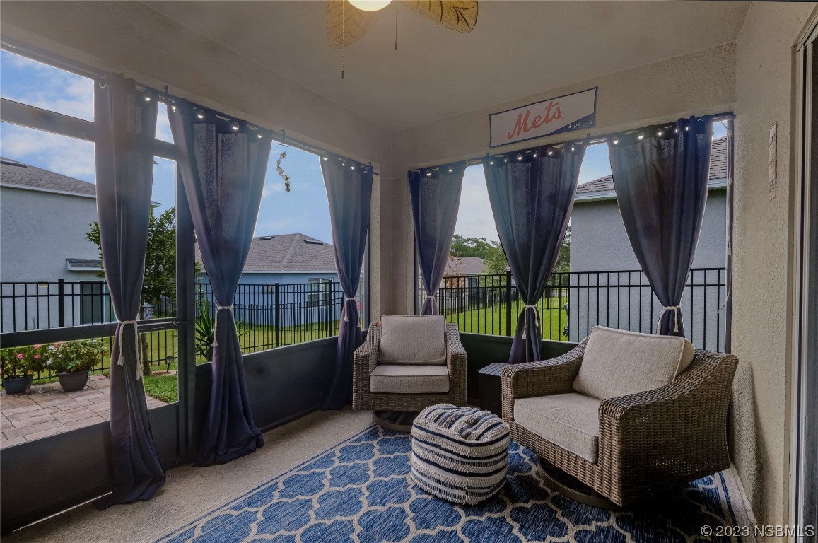 354 Camilla Road DeLand, FL 32724 - Photo 34 of 57 a living room with furniture and a floor to ceiling window